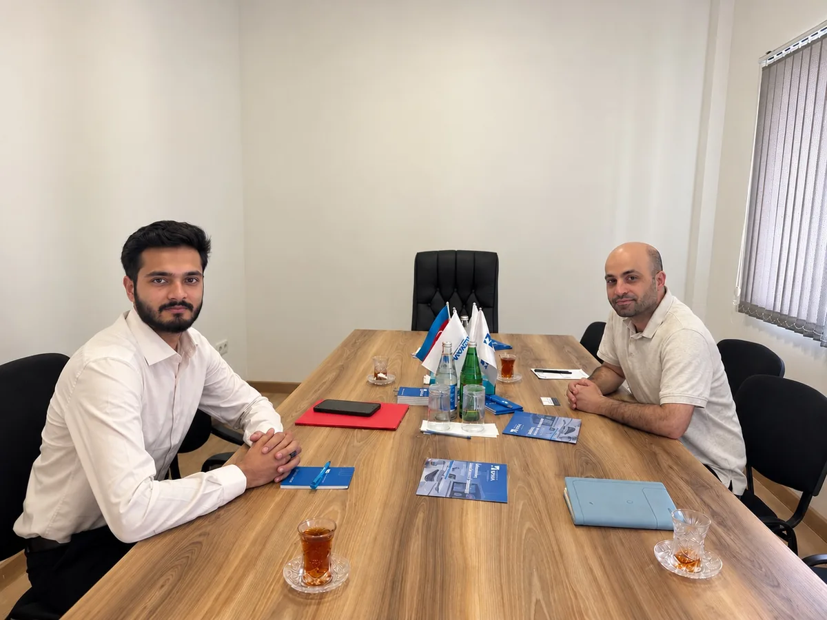 Daim Ali and Mr. Farid seated at a conference table with Viva Medical materials