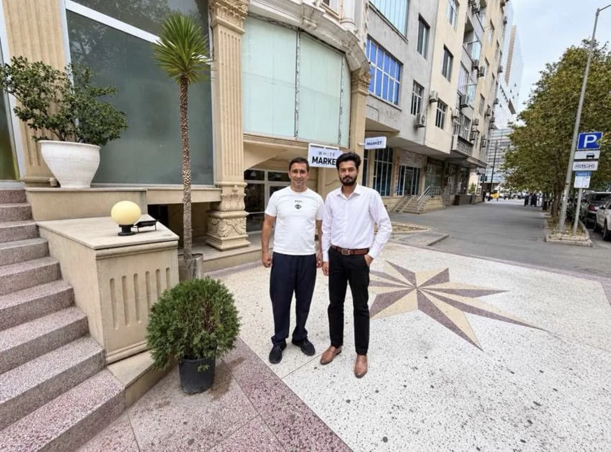 Mr. Babak and Daim Ali standing outside White Market in Baku